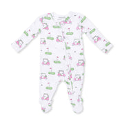A white long-sleeve baby footed sleeper with an all-over golf-themed print featuring pink carts, green holes, and flags.