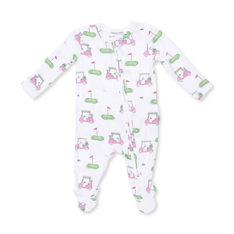 A white long-sleeve baby footed sleeper with an all-over golf-themed print featuring pink carts, green holes, and flags.