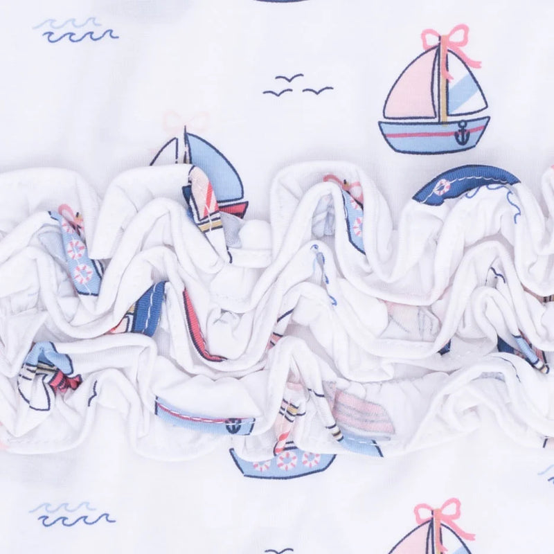 a ruffled edge, featuring a nautical sailboat pattern in shades of blue, pink, and red.