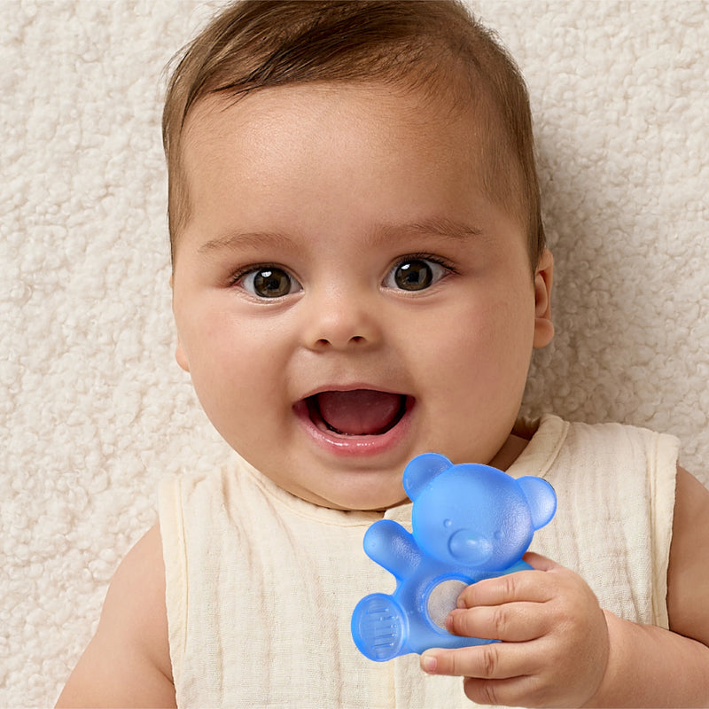 Smiling baby holding the blue bear Itzy Ritzy Cutie Coolers water-filled teether