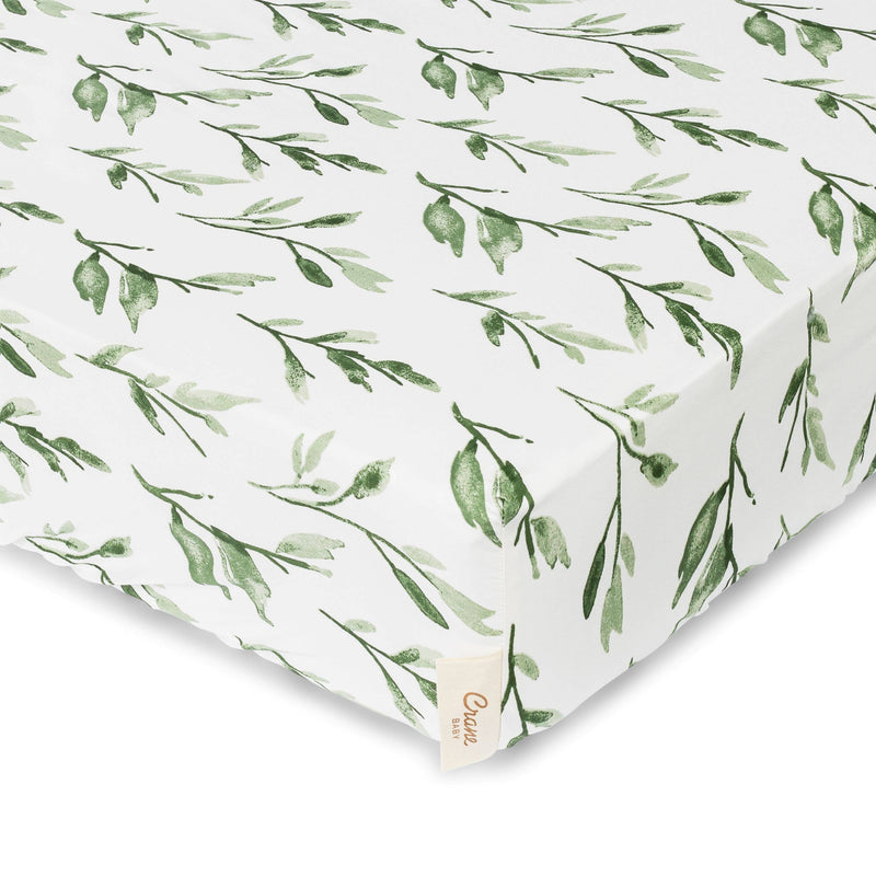 Fitted sheet with green leaf pattern on a white background