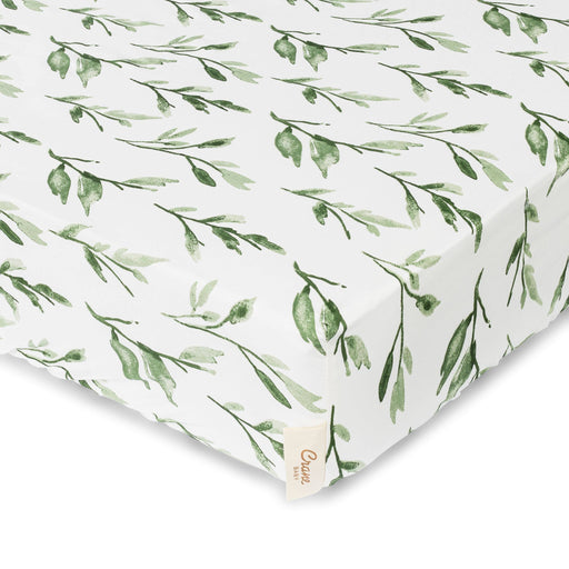 Fitted sheet with green leaf pattern on a white background