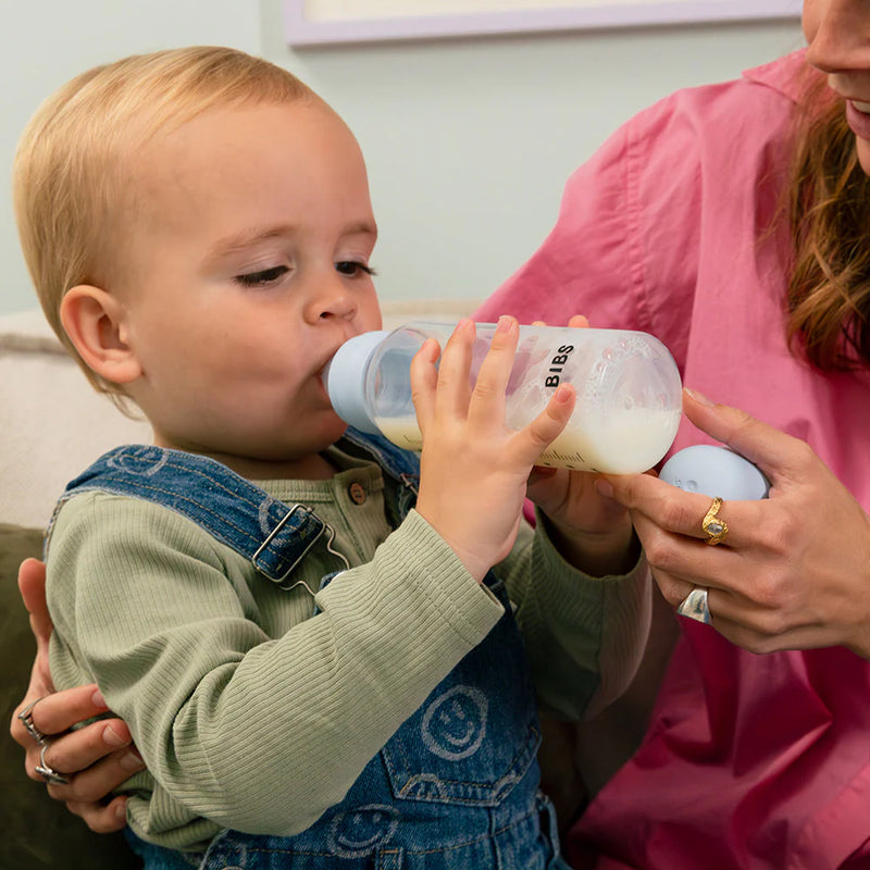 Baby being bottle-fed with a BIBS silicone baby bottle during feeding time
