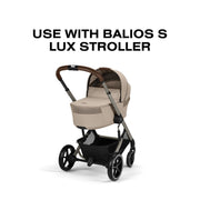Cybex Balios Fold Cot in Almond Beige attached to the Balios S Lux stroller