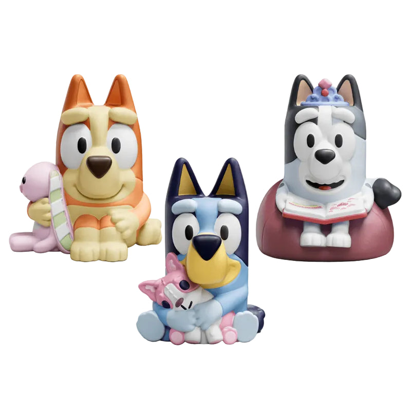 Three colorful dog figurines on a white background