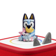 Toy figure of a cartoon character on a red and white base with shark fin design
