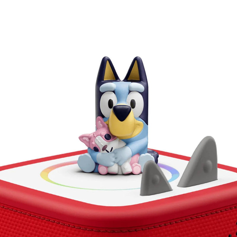 Toy figure of a cartoon character on a red and white base with shark fin design