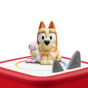 Toy figure of a dog with a small animal on a red and white base