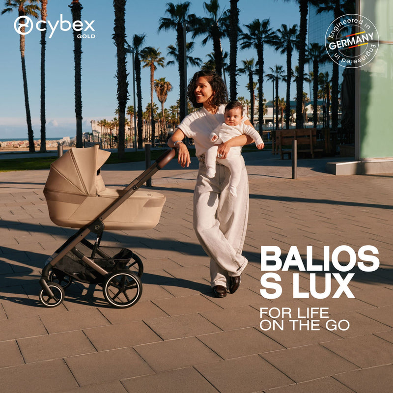 Mom and baby walking with Cybex Balios S Lux stroller and Fold Cot by palm trees