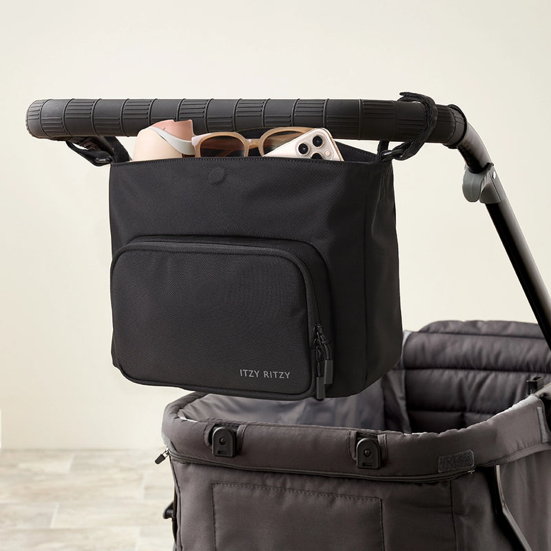 Itzy Ritzy caddy attached to a stroller handle using stroller straps