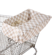 Itzy Ritzy shopping cart cover fitted over a standard metal shopping cart seat