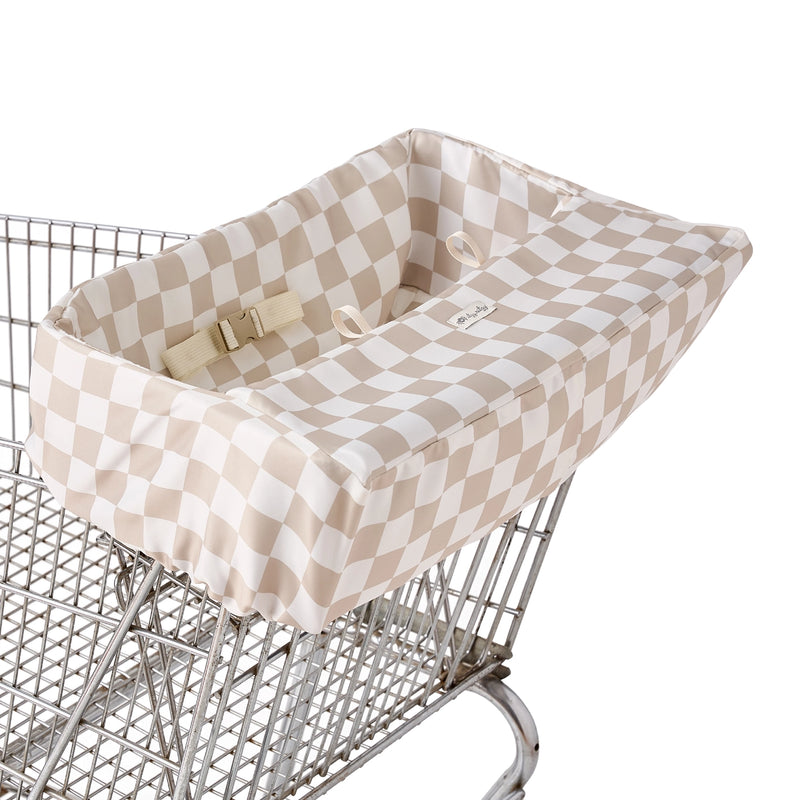 Itzy Ritzy shopping cart cover fitted over a standard metal shopping cart seat