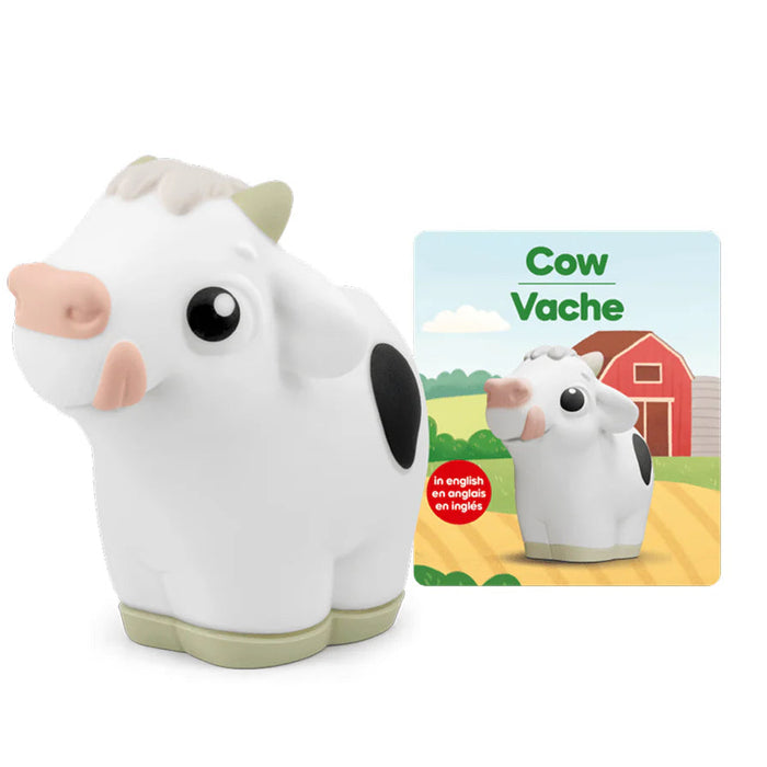 Toy cow with a matching book titled 'Cow Vache' on a white background