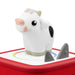 Toy cow on a red tonies box with a white background