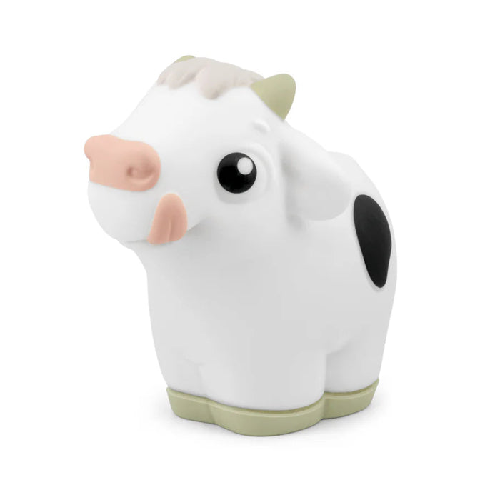 White cow tonies character with black spots on a white background