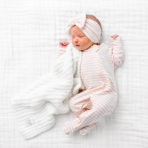 Sleeping newborn in the Lou Lou & Co Harper pink striped ribbed zipper footie and bow headband