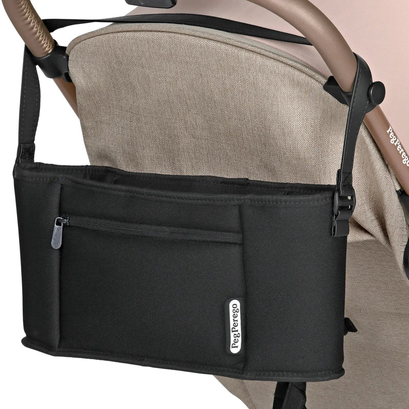 Black stroller organizer with a visible brand logo attached to a beige stroller.