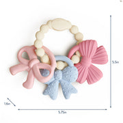 Silicone teething ring with three textured charms shown on a white background