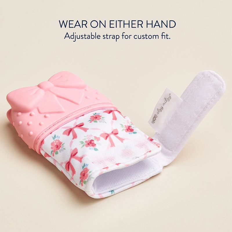 Silicone teether mitt laid flat showing adjustable closure and soft fabric construction