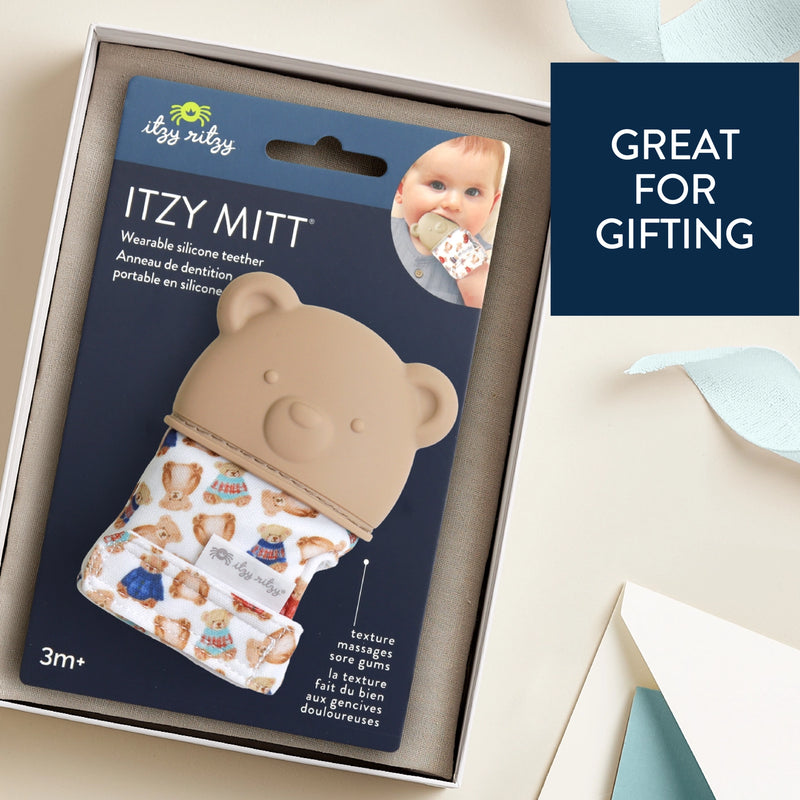 Itzy Ritzy silicone teether mitt displayed in retail packaging labeled as a giftable baby item