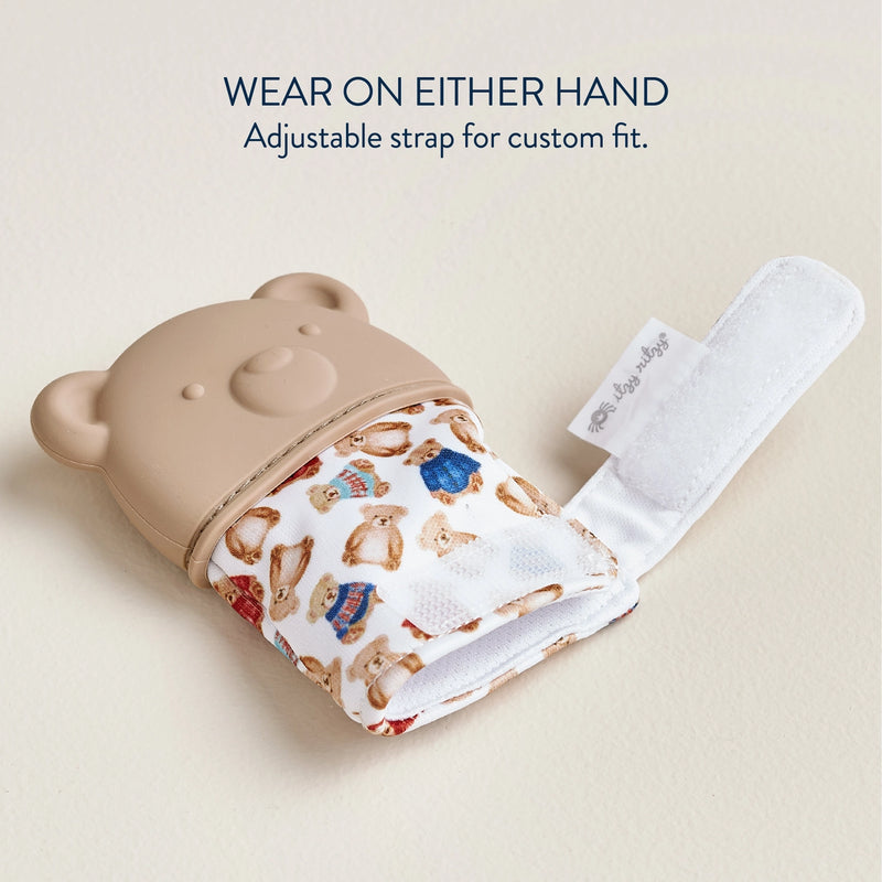 Itzy Ritzy teether mitt laid flat to show adjustable strap