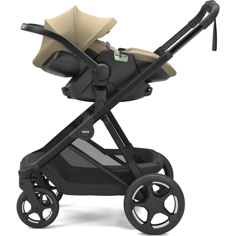 Thule Charm stroller in Faded Khaki with Thule Maple infant car seat attached