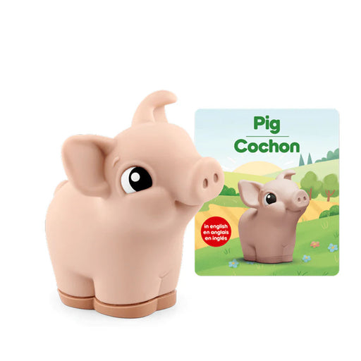 Toy pig with a book about pigs on a white background