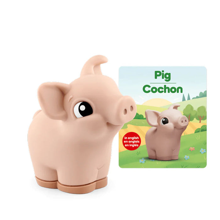 Toy pig with a book about pigs on a white background