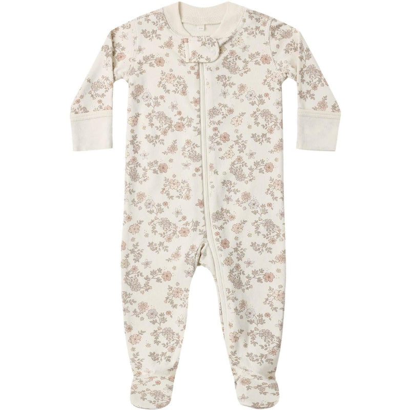 A long-sleeve baby footed sleeper in cream with a delicate pink and beige floral pattern, featuring a snap closure down the front.