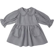 A gray long-sleeve baby dress with a ruffled Peter Pan collar, gathered sleeves, and two front patch pockets with matching ruffle trim, shown on a plain white background.