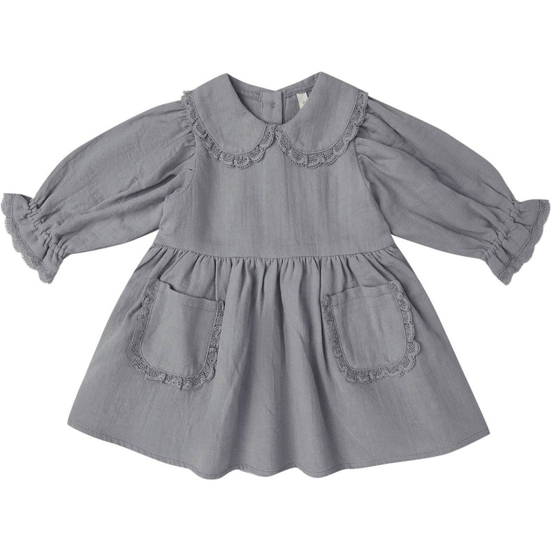 A gray long-sleeve baby dress with a ruffled Peter Pan collar, gathered sleeves, and two front patch pockets with matching ruffle trim, shown on a plain white background.