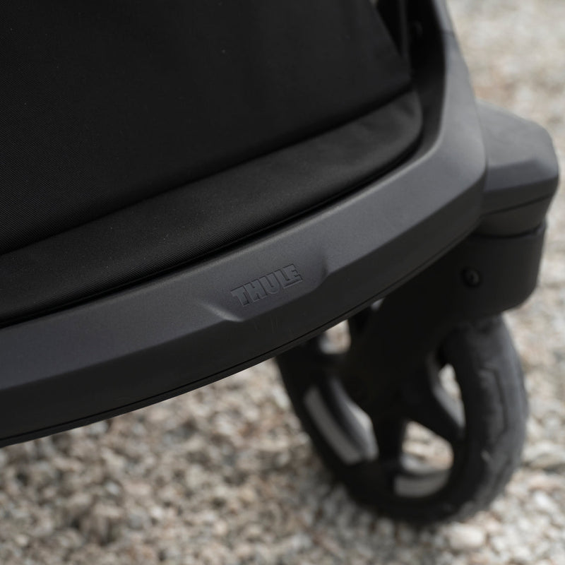 Close-up of Thule Charm stroller wheel and frame