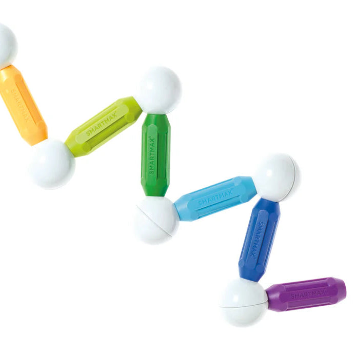 Colorful magnetic toys arranged in a circular pattern on a white background