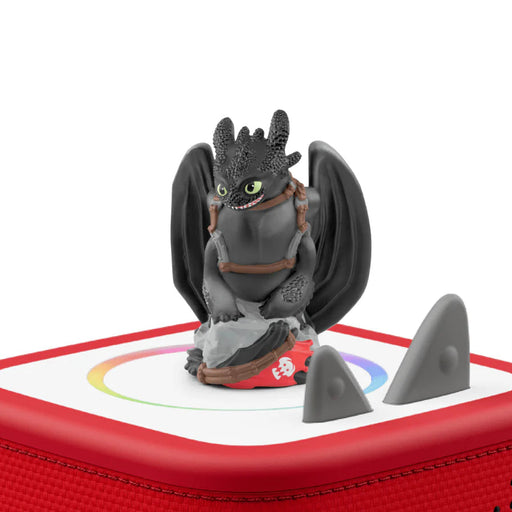 Toy dragon figure on a red and white base with a white background