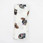 baby blanket featuring a scattered print of wild turkeys in black, brown, and blue, with a small red comb detail, shown on a plain white background.