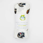 A rolled white baby scarf or shawl with a butterfly print, wrapped in a paper band that reads 'Muir Waterdale' and 'BATTLES | SCARVES | SASHES'.