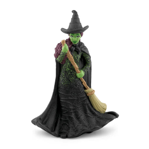 Toy figure of a witch with a broom on a white background