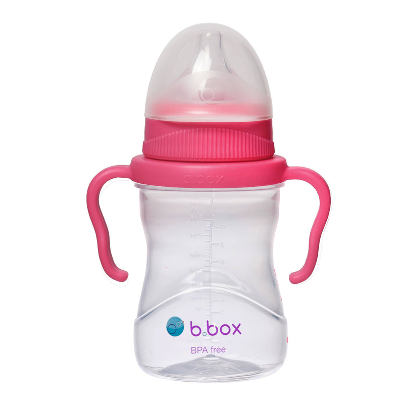 Pink and clear baby bottle with handles on a white background, featuring the b.box logo.