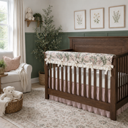 Nursery room with wooden crib, floral crib sheet, and decorative elements.