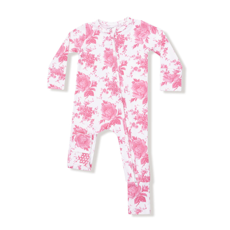 Long sleeve two-way zipper romper in white with vintage pink roses print, foldover foot cuffs shown flat