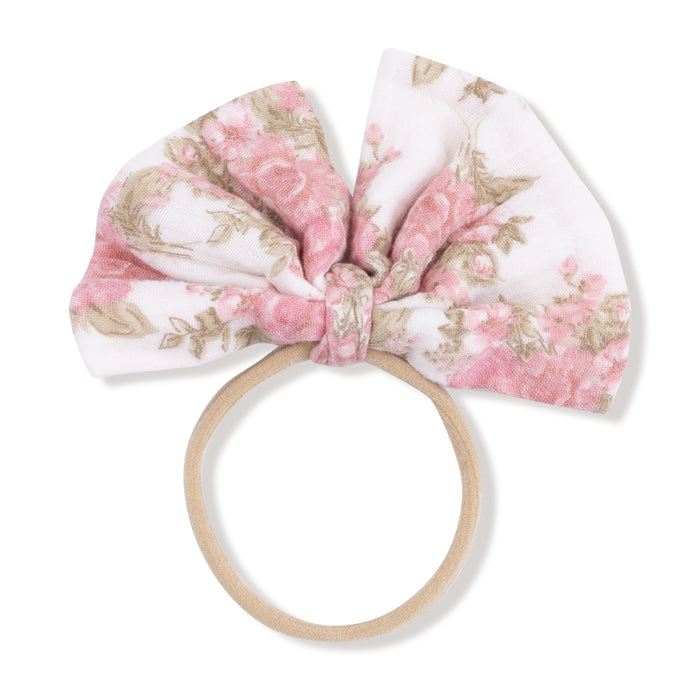 Big bow baby headband in heirloom bouquets floral, soft nude elastic band shown flat