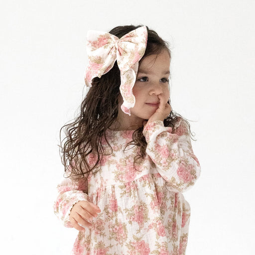 Toddler wearing heirloom bouquets bow with tails in hair