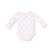 Long sleeve lap-shoulder bodysuit in pink ribbon bow trellis print, front flat lay