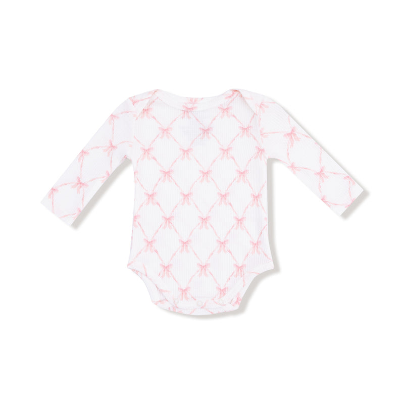 Long sleeve lap-shoulder bodysuit in pink ribbon bow trellis print, front flat lay