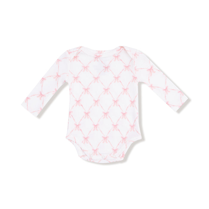 Long sleeve lap-shoulder bodysuit in pink ribbon bow trellis print, front flat lay