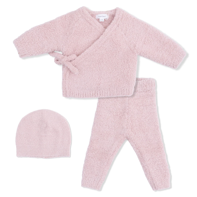 Pink baby outfit with a cardigan, pants, and hat on a white background
