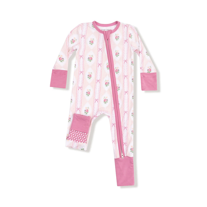 Pink and white baby onesie with floral pattern on a white background