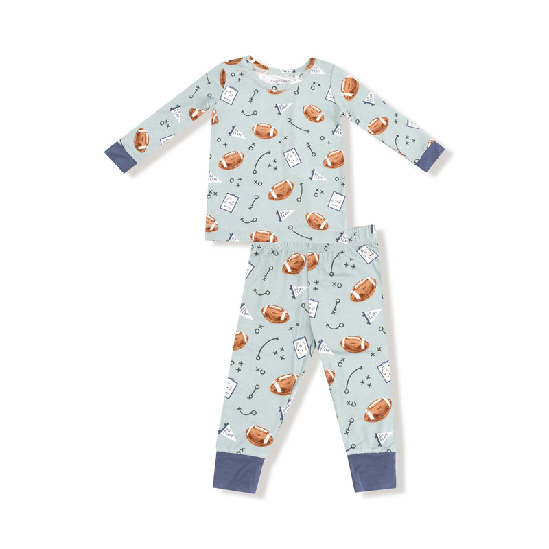Children's onesie with football-themed pattern on a light blue background