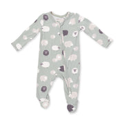 A baby long-sleeve footed sleeper in sage green with a pattern of sheep in white, light pink, and dark purple, featuring a front zipper.