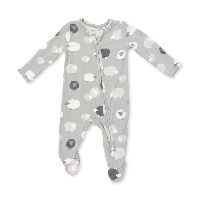 A baby long-sleeve footed sleeper in sage green with a pattern of sheep in white, light pink, and dark purple, featuring a front zipper.